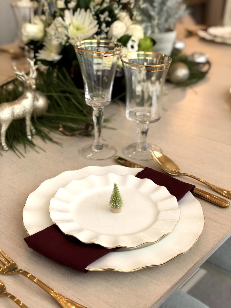 Holiday Table Settings with lots of texture, white ruffle plates, and sparkly reindeer.  